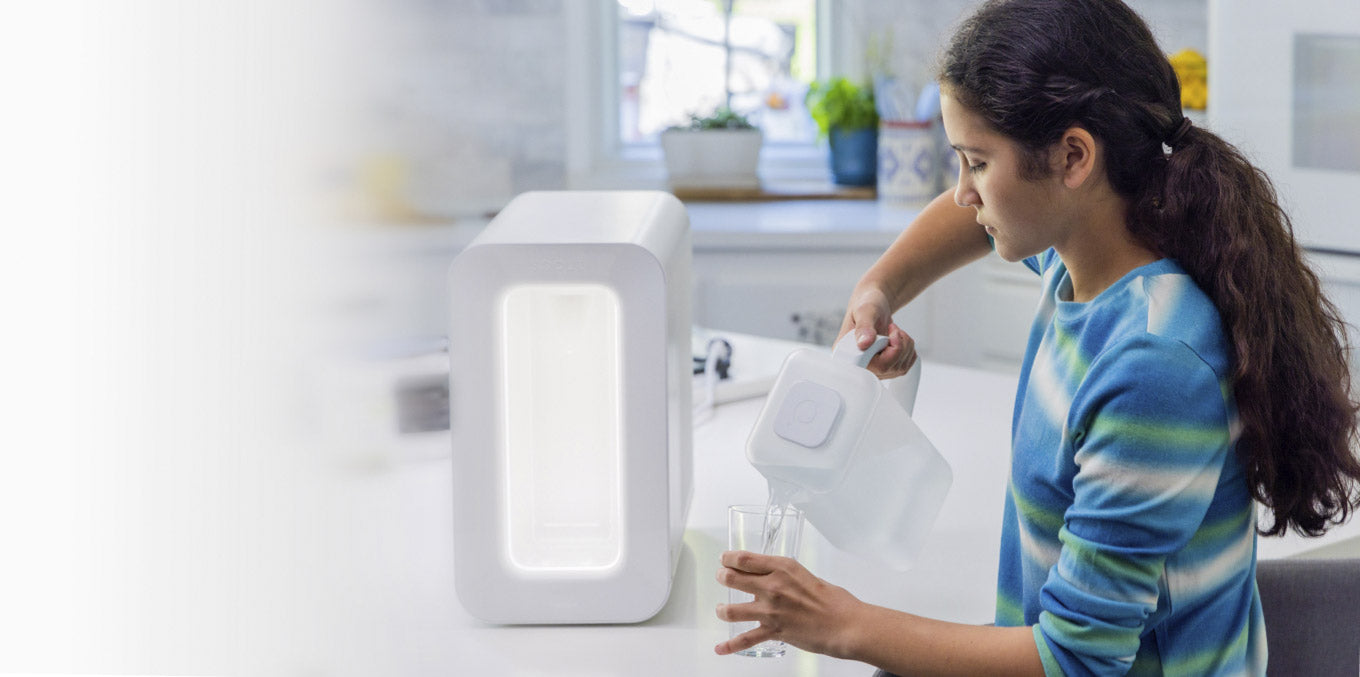 girl pouring a glass of water from always fresh spout pitcher